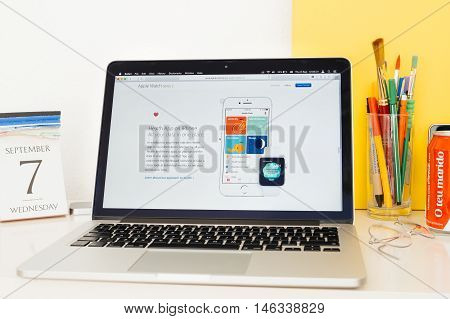 PARIS FRANCE - SEP 8 2016: Apple Computers website on MacBook Pro Retina in a geek creative room environment showcasing new Apple Watch Series 2 with health app on iphone
