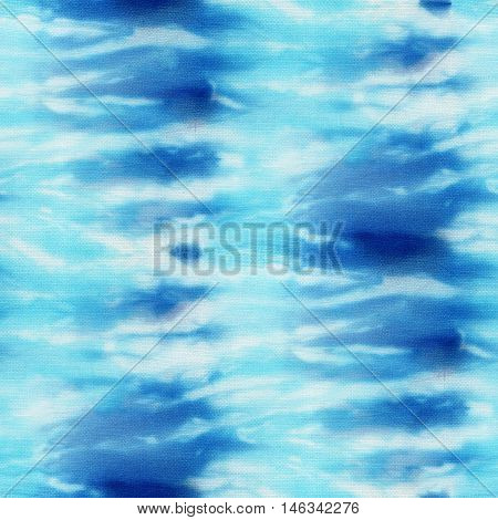 Seamless tie-dye pattern of indigo color on white silk. Hand painting fabrics - nodular batik. Shibori dyeing.