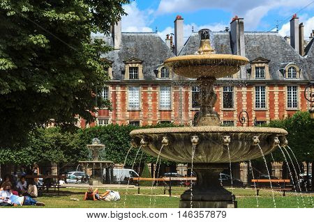 PARIS, FRANCE-JULY 29, 2016:   The historical famous Place des Vosges in Paris