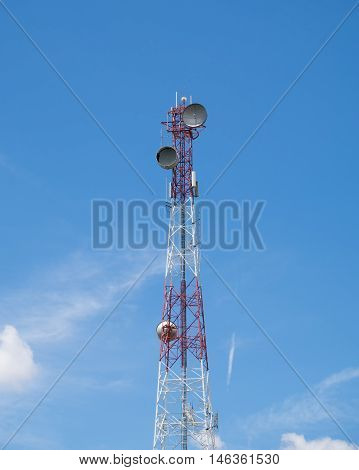 Communication tower antenna center on blue sky and clouds