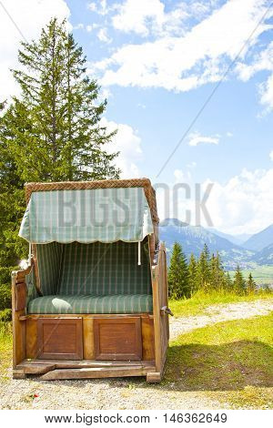 View at vintage old chair near Ehrwalder Almsee with mountain landscape Tirol Austria