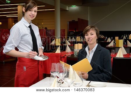 young waitress listed order of the guest