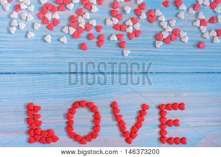Red Candy Hearts Laying On Light Blue Painted Rustic Wooden Background