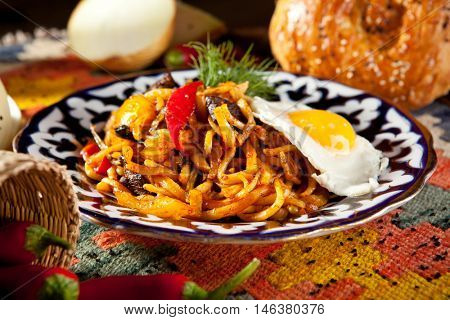 Asian Style Noodles with Meat and Laghman Sauce. Garnished with Fried Egg