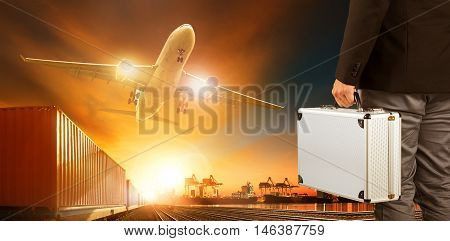 business man and metal breifcase standing in front of cargo plane and logistic industry trains and shipping port