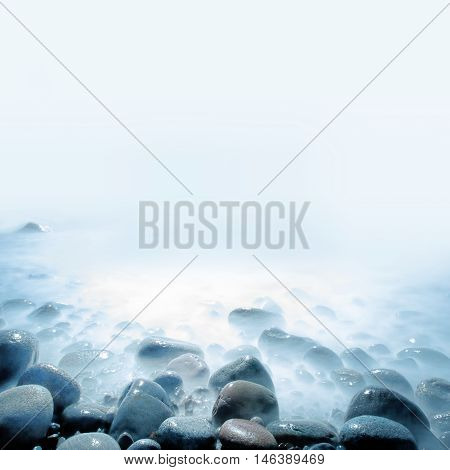 Background of water and rolling stones at Moelen