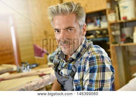 Carpenter working wood in workshop