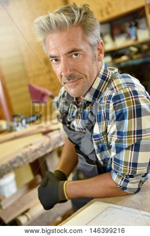 Carpenter working wood in workshop