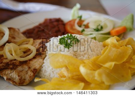 rice with chicken beans and salad from Nicaraguan cuisine