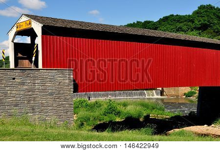 Asheville Pennsylvania - June 6 2015: 1884 vernacular Burr arch-truss wooden covered bridge over the Octoraro Creek