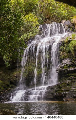 Beautiful waterfall between rocks in sunny day.