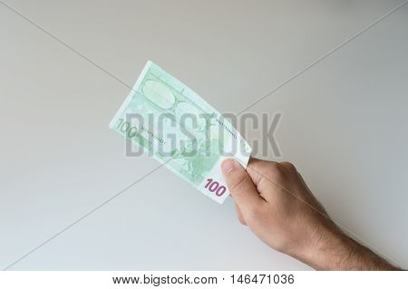Man holding one hundred Euro banknote in his hands