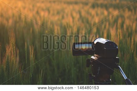 Video camera on a tripod at sunset