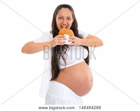 Pregnant woman with big tummy eating unhealthy hamburger and smiling. Isolated on white background.