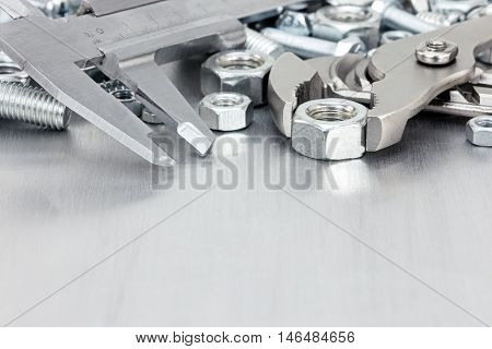 Various Hand Tools And Screws On Scratched Metal Background