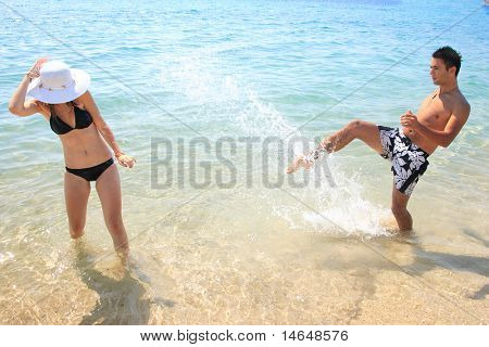 En attraktiv par leger på stranden