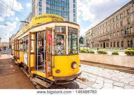 Milan, Italy - June 06, 2016: Old yellow tram with passengers on the street in Milan. The ATM Class 1500 is a series of tram vehicles used from 1927 year by the ATM in Milan