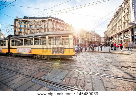Milan, Italy - June 06, 2016: Yellow tram on Cordusio square in Milan. Cordusio in one of Milan's two main town squares and is a major transportation hub.