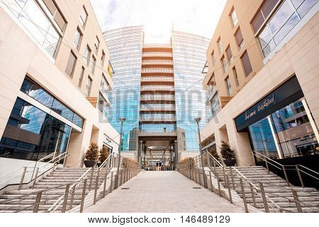 Milan, Italy - June 07, 2016: Vincenzo Capelli street with shopping boutiques and Unicredit skyscraper in Porta Nuova business district in Milan.