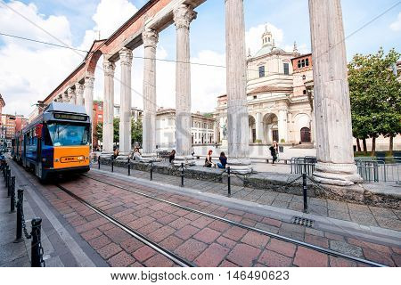 Milan, Italy - June 07, 2016: Street view with San Lorenzo Maggiore basilica, columns and old tram in Milan city.