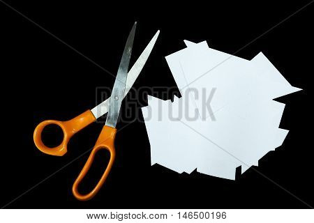 Clear paper cutting and scissors is isolated on black background