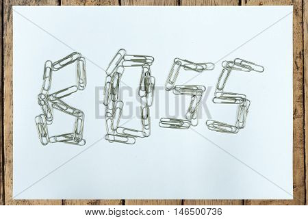 Clear paper on wood table with boss cilping is isolated on black background