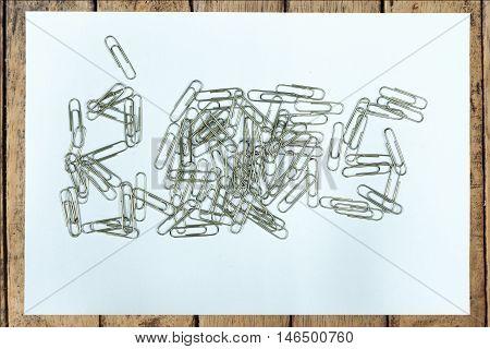 Clear paper on wood table with boss fail cilping is isolated on black background