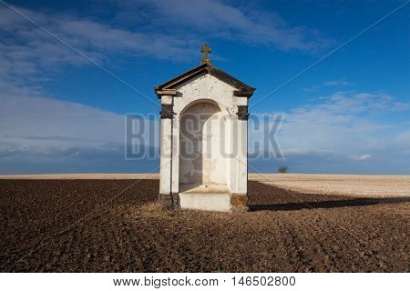 A small chapel on the empty autumn field