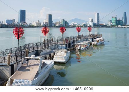 DANANG, VIETNAM - JANUARY 06, 2016: Berth tourist boats on the Han River on a sunny morning. Tourist landmark of the city Danang