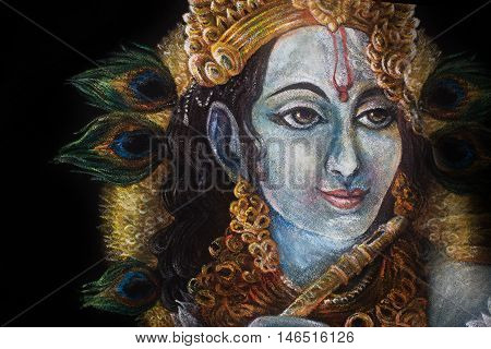 head of krishna with peacock feather and jewelry, hand painted.