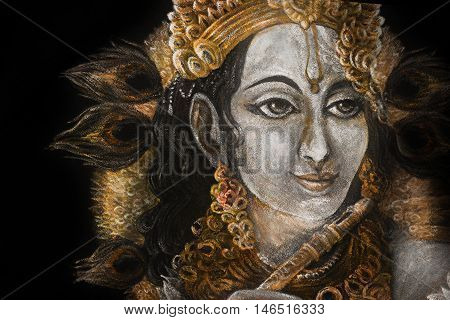 head of krishna with peacock feather and jewelry, hand painted.