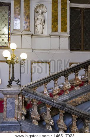 MILAN, ITALY - APRIL 16 2015: Architectural close up of the monumental staircase of Palazzo Arese Litta in Milan with classic statues and marble decorations