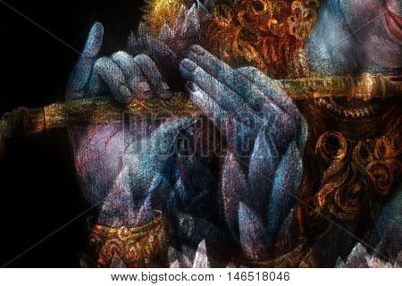 hands of lord krishna playing flute, detail with lotus pattern.