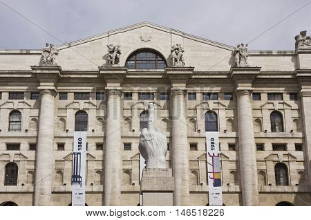 MILAN, ITALY - APRIL 16 2015: Controversial sculpture L.O.V.E. by Italian Maurizio Cattelan in front of stock exchange building in Piazza Affari Milan