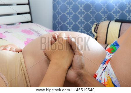 Close Up Pregnant Woman On Bedroom Background