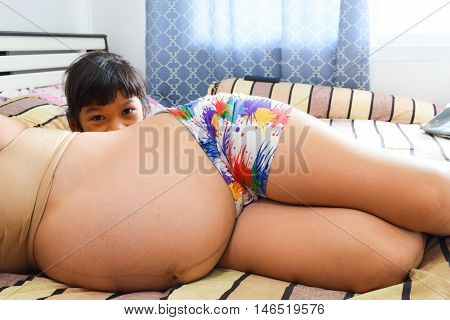 Close Up Pregnant Woman On Bedroom Background