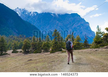 Young Pretty Woman Wearing Red Jacket Backpack Trail Mountains.Asia Mountain Trekking Rocks Path Landscape View Background. Girl Happy Hikking Route.Horizontal Photo