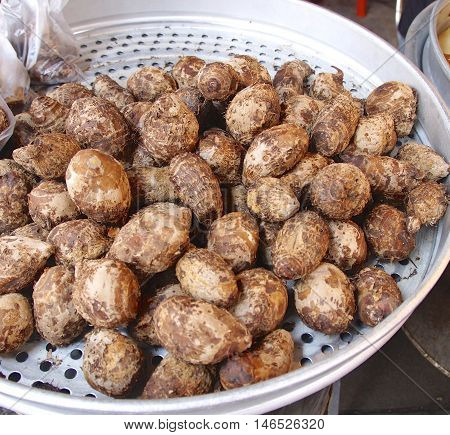 Fresh taro for sale closeup in market .
