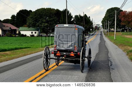 Lancaster County Pennsylvania - October 13 2015: An Amish buggy driving along Route 772 near Intercourse Pennsylvania