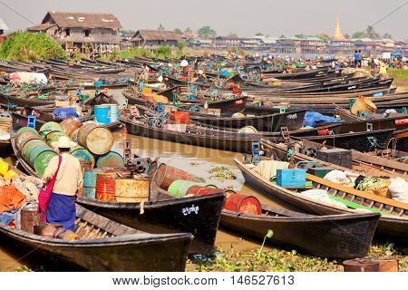 Heho Myanmar - March 02 2011 - Burmese people trading at an floating market. Boats are full of gasoline and other goods