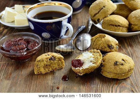 Pumpkin scones with dried fruit for breakfast served with jam and butter