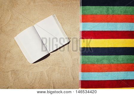 Top view of sandy beach with summer accessories and copy space around products. Blank mock up for blog, advertising or packaging.