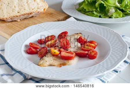 Sea bass fillet baked with cherry tomatoesitaly