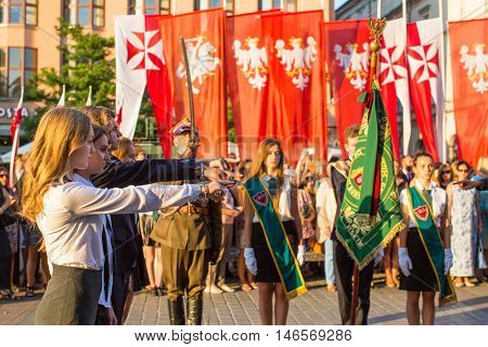 KRAKOW, POLAND - FEB 10, 2016: Unidentified participants of ceremony is the vow of first classes of the Jan III Sobieski High School (founded in 1883) at the Main Market Square near St.Mary Cathedral.