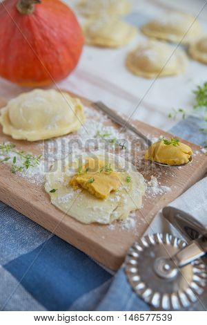 homemade stuffed with pumpkin ravioli on a wooden board