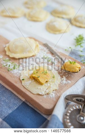 homemade stuffed with pumpkin ravioli on a wooden board