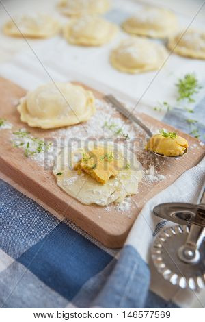 homemade stuffed with pumpkin ravioli on a wooden board