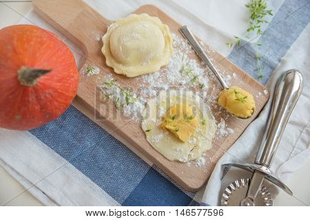 homemade stuffed with pumpkin ravioli on a wooden board