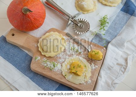 homemade stuffed with pumpkin ravioli on a wooden board