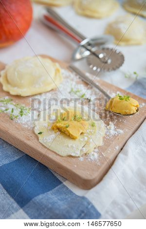 homemade stuffed with pumpkin ravioli on a wooden board